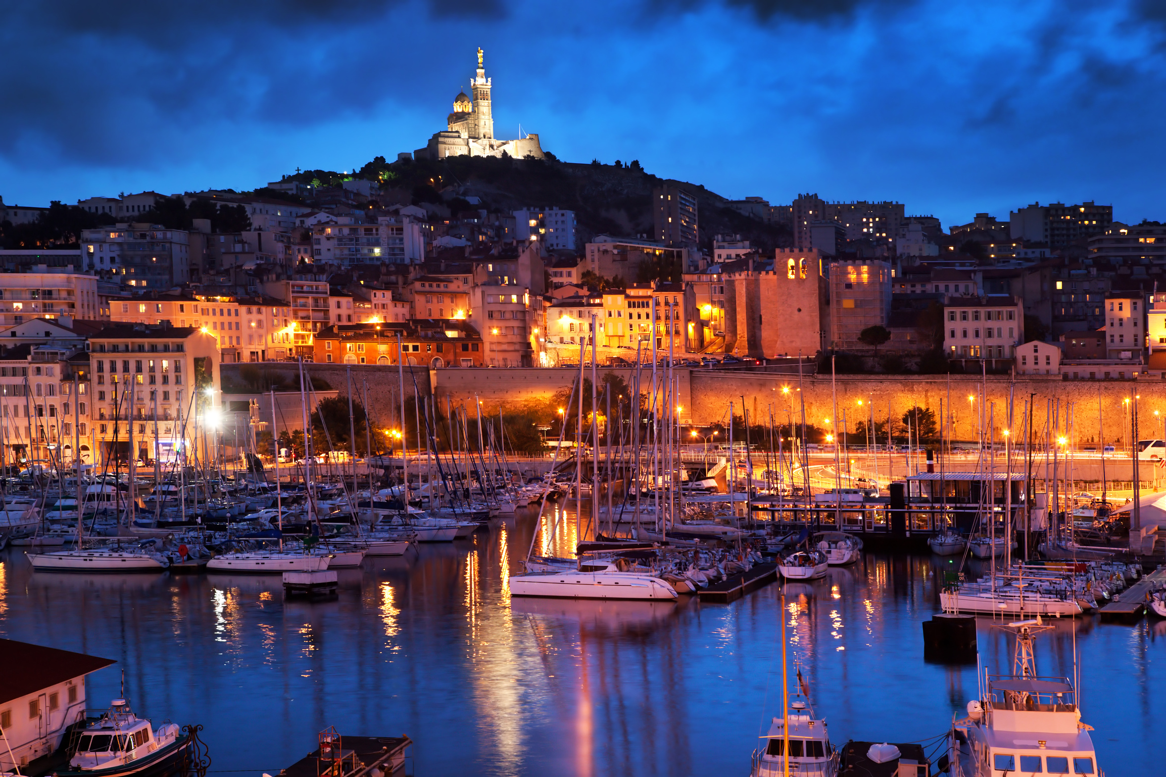 Marseille, France panorama at night. The famous european harbour view on the Notre Dame de la Garde